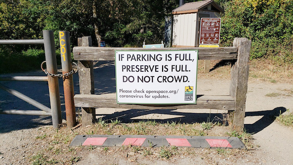 Sign on fence: If parking is full, preserve is full. Do not crowd.