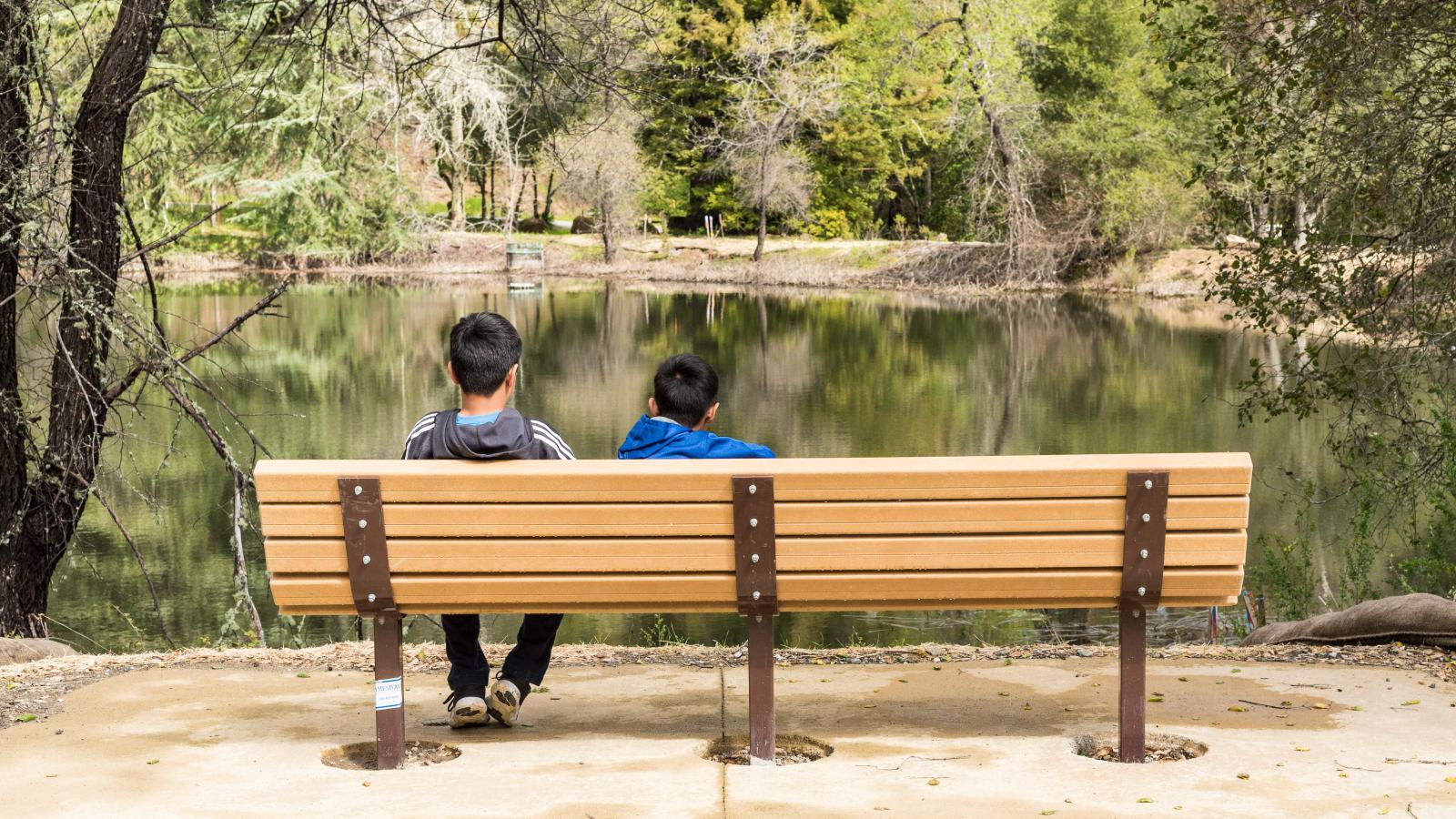 Children resting on bench along Upper Lake Loop interpretive trail, Bear Creek Redwoods Preserve / photo by Alisha Laborico