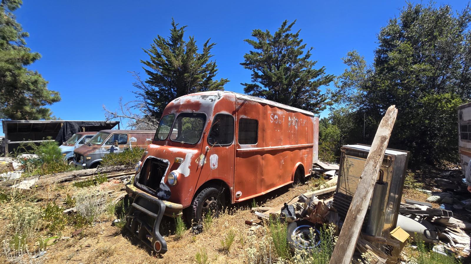 A rusted red van sits among other debris in a newly acquired property added to Sierra Azul Open Space Preserve