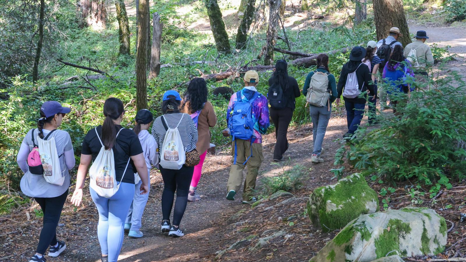 A group of hikers on a trail in a Midpen preserve.