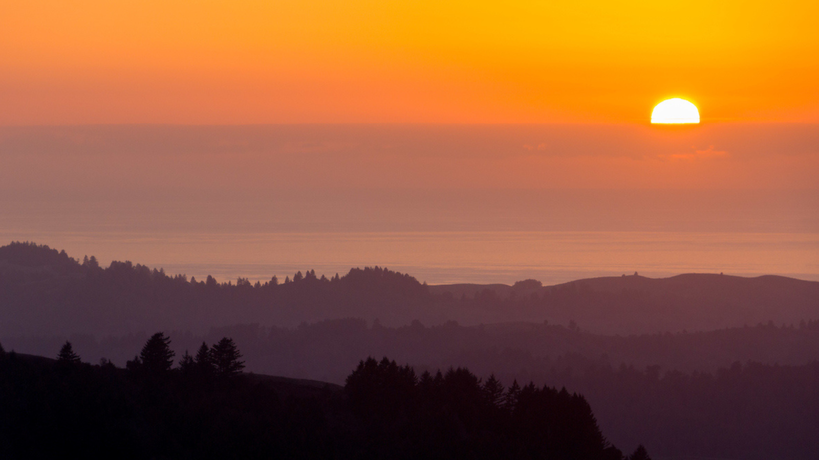 vista of mountains, sun and ocean