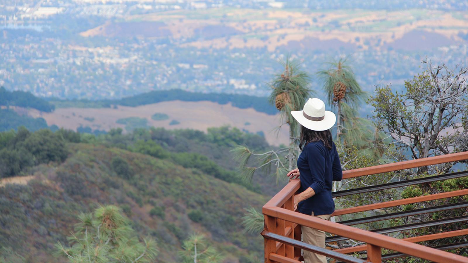 a woman standing on an overlook