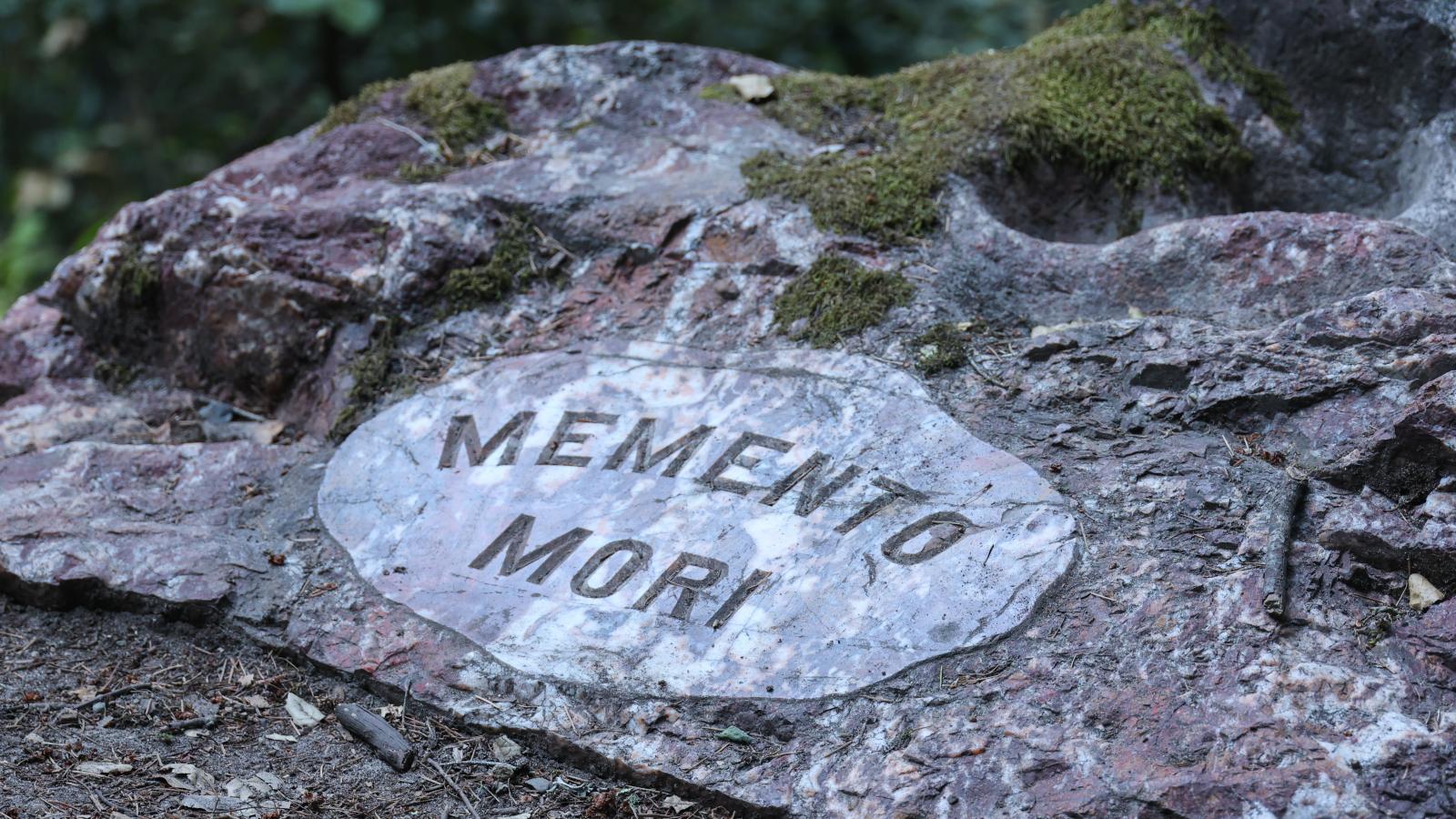 A rock inscribed with the words, "Memento Mori".
