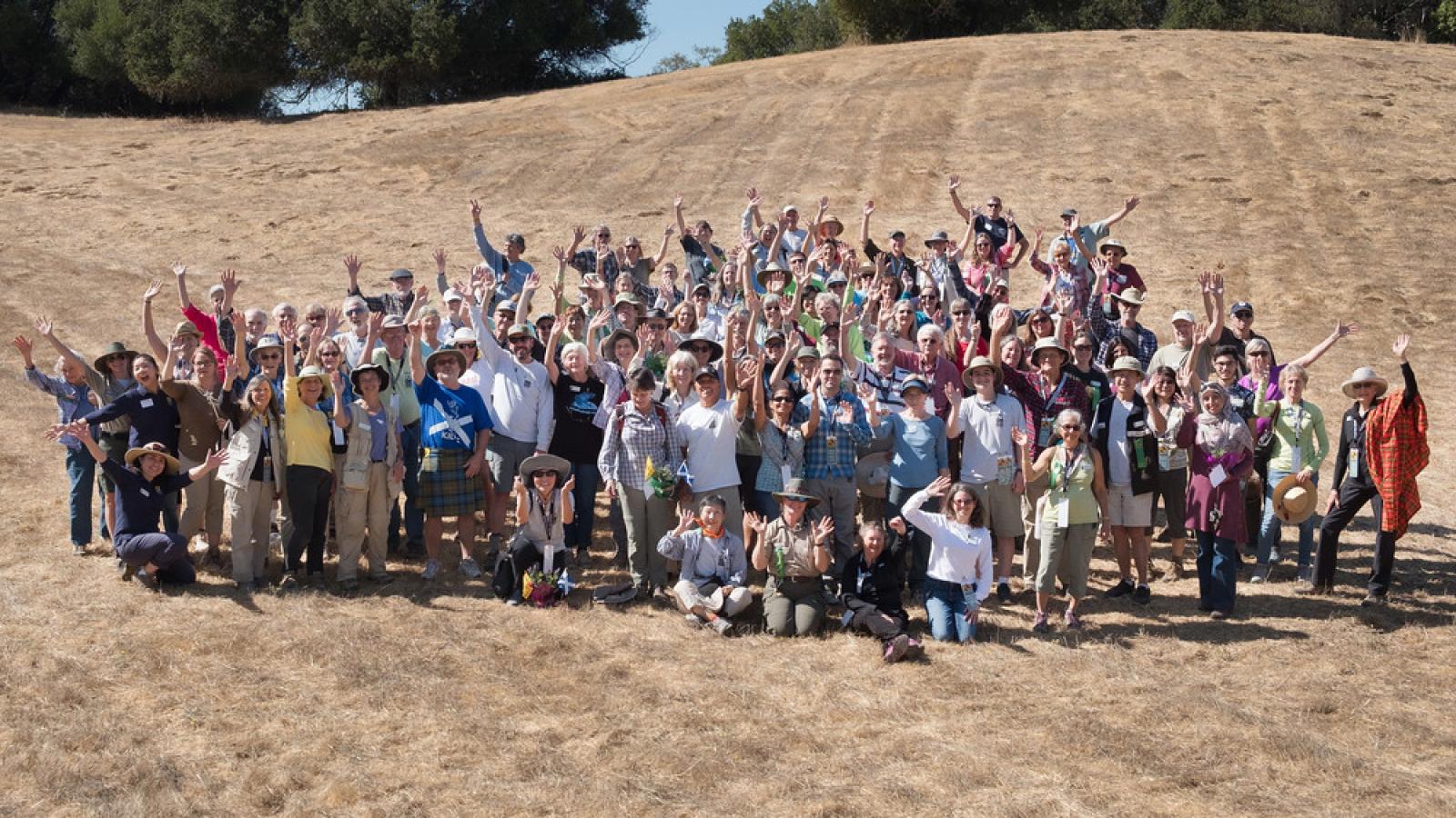 a group of people standing on a hill
