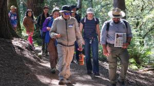 Group of people hike along a trail in El Corte de Madera Creek Preserve