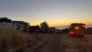 Fire and ranger trucks at sunrise