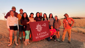 Latino Outdoors members holding banner at Monte Bello Preserve