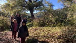 A group of kids walk single file along a trail in Picchetti Ranch Preserve