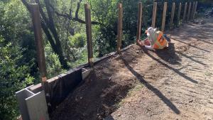 Construction worker installing retaining wall in Bear Creek Redwoods