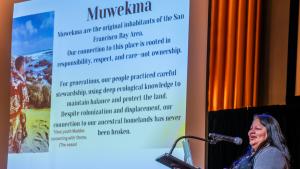 A speaker from the Muwekma Ohlone Tribe speaking at the first Science and Stewardship Symposium