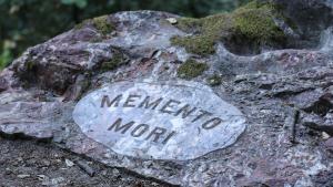 A rock inscribed with the words, "Memento Mori".