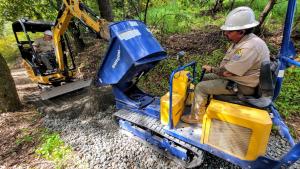Midpen trail crew use construction equipment to build a trail