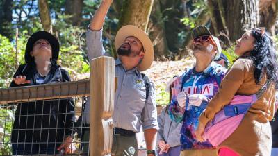 A Midpen ranger leading a group hike in a preserve for Latino Conservation Week.