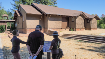 Visitors looking at display in front of Alma College site