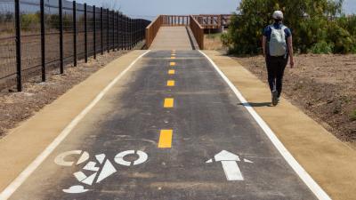 a person walking alongside a bike path