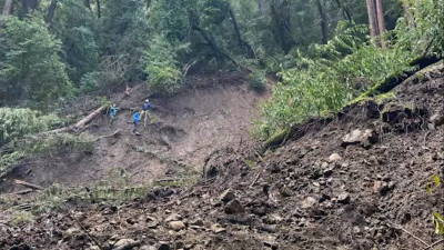 Staff inspect damage from large landslide