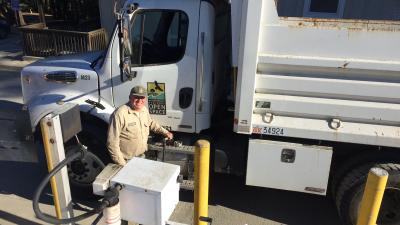 Man fueling Midpen truck with renewable diesel