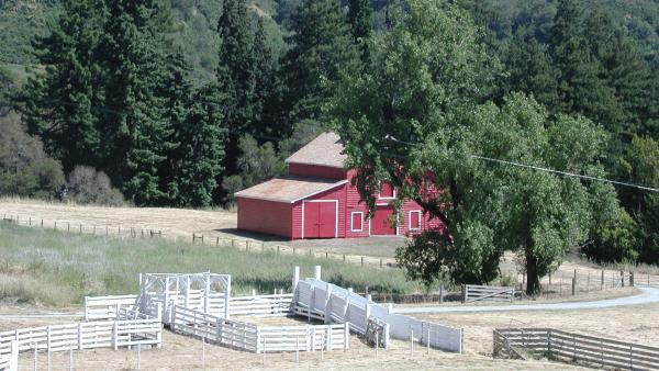 The Red Barn in La Honda Open Space Preserve and nearby white fencing and corrals