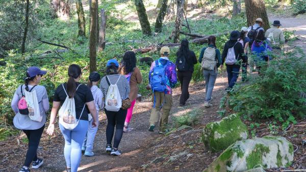 A group of hikers on a trail in a Midpen preserve. 