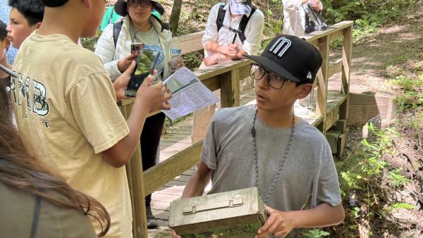 Kids from the Boys and Girls Club of Coastside discover a geocache in Los Trancos Preserve