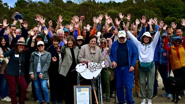 Attendees to Lennie Roberts' trail dedication event pose for a commemorative photo