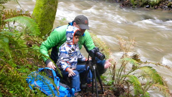 People taking photographs near creek