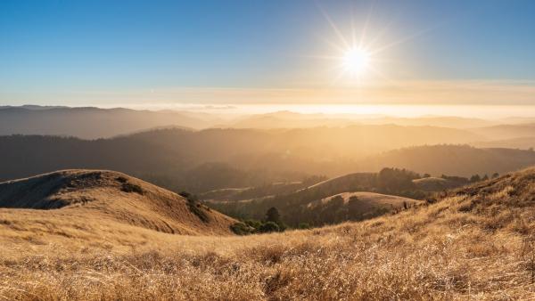 sunset over golden hills