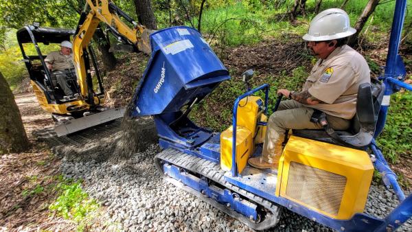 Midpen trail crew use construction equipment to build a trail