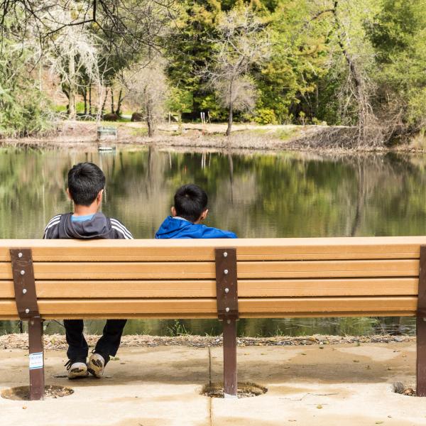 Children resting on bench along Upper Lake Loop interpretive trail, Bear Creek Redwoods Preserve / photo by Alisha Laborico