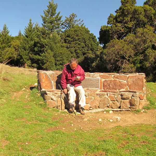 a man sitting on a stone bench