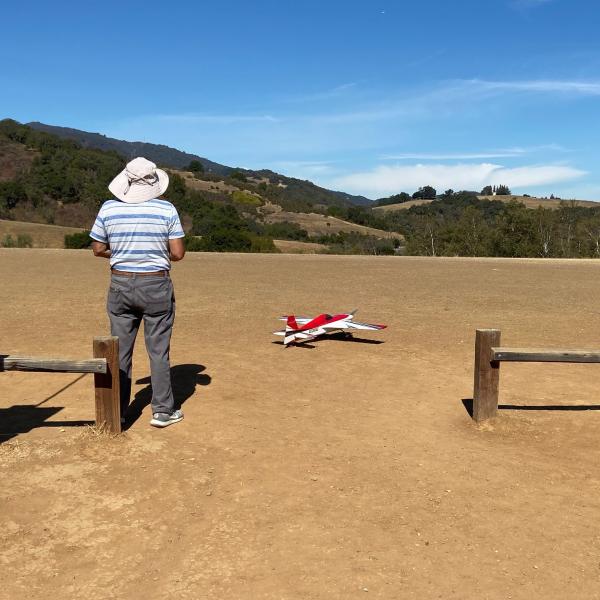 a man flying a model airplane