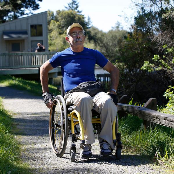 Photo: John Green a man in a wheelchair on a trail