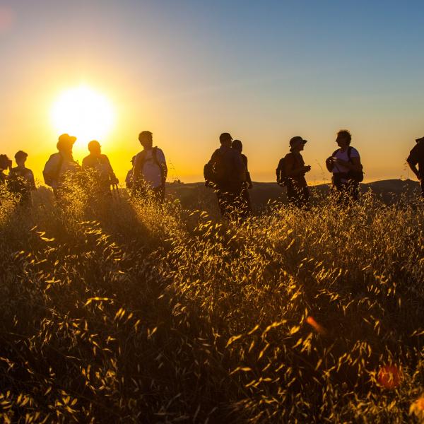 Hikers enjoying sunset sky at Monte Bello Preserve