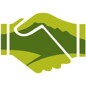 Icon of shaking hands with a mountain in the background.